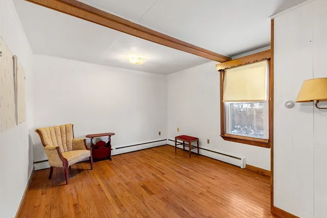 a view of room with hardwood floor and window