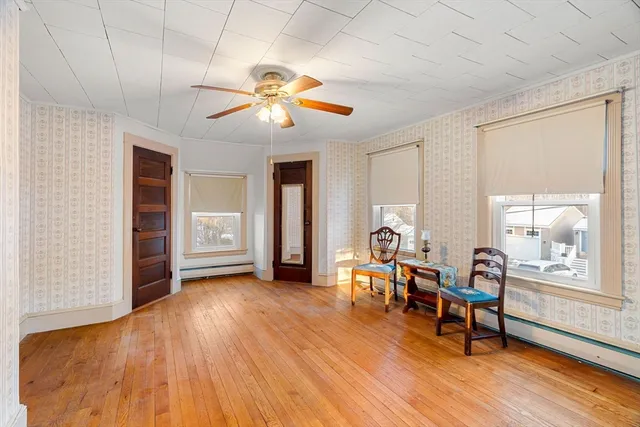 a living room with furniture and wooden floor
