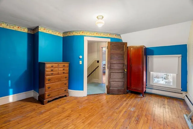 a view of an empty room with window and closet