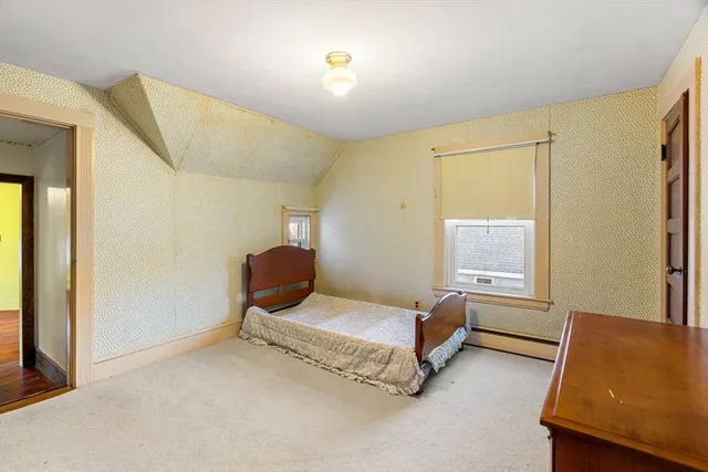 a bedroom with furniture and a window