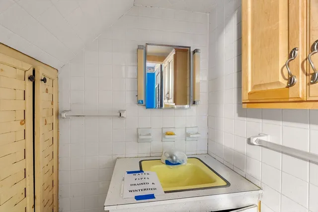 a bathroom with a tub sink and mirror