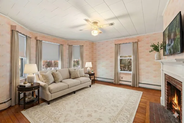 a living room with furniture a fireplace and a flat screen tv