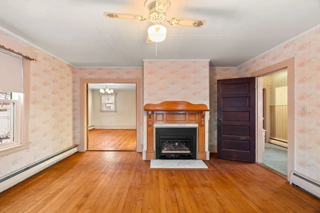 a view of an empty room with a fireplace and a window
