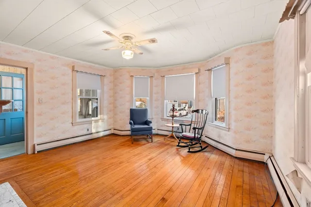 a view of a livingroom with workspace and a window