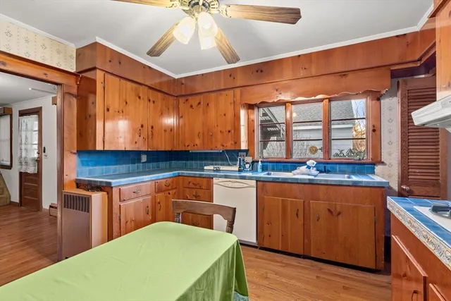 a kitchen with a sink cabinets and wooden floor