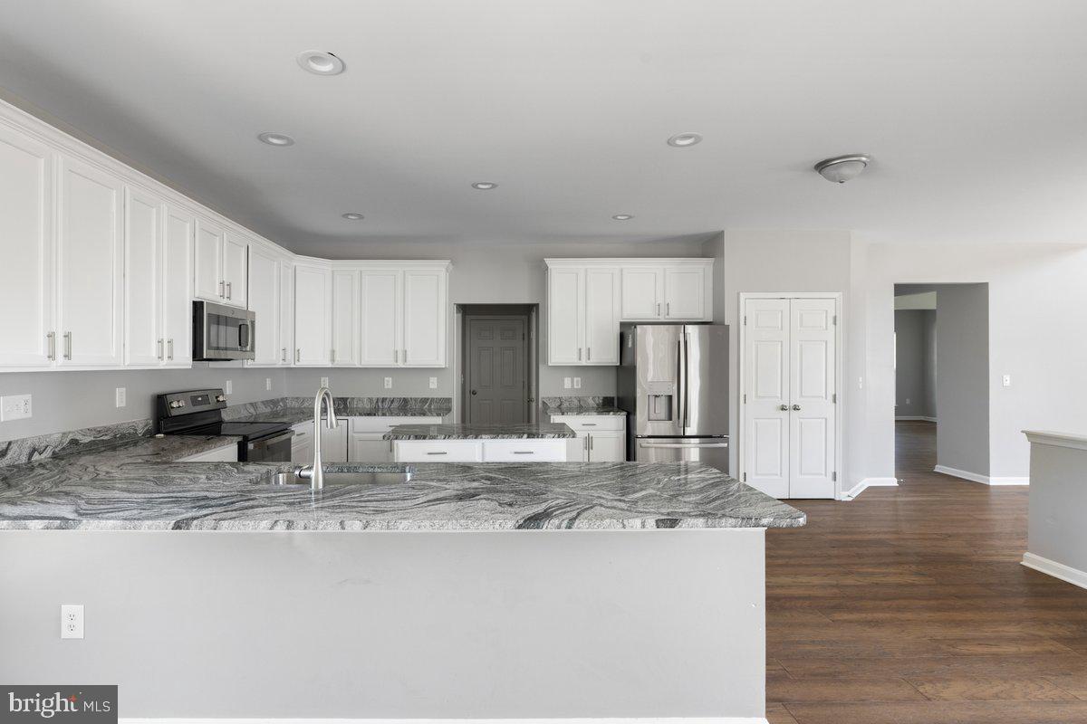 12 Glenbrook Road Ranson, WV 25438 - Photo 11 of 35 a kitchen with stainless steel appliances granite countertop a sink refrigerator and cabinets