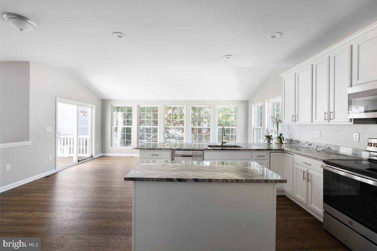 12 Glenbrook Road Ranson, WV 25438 - Photo 12 of 35 a large kitchen with granite countertop a sink and dishwasher a stove top oven with wooden floor