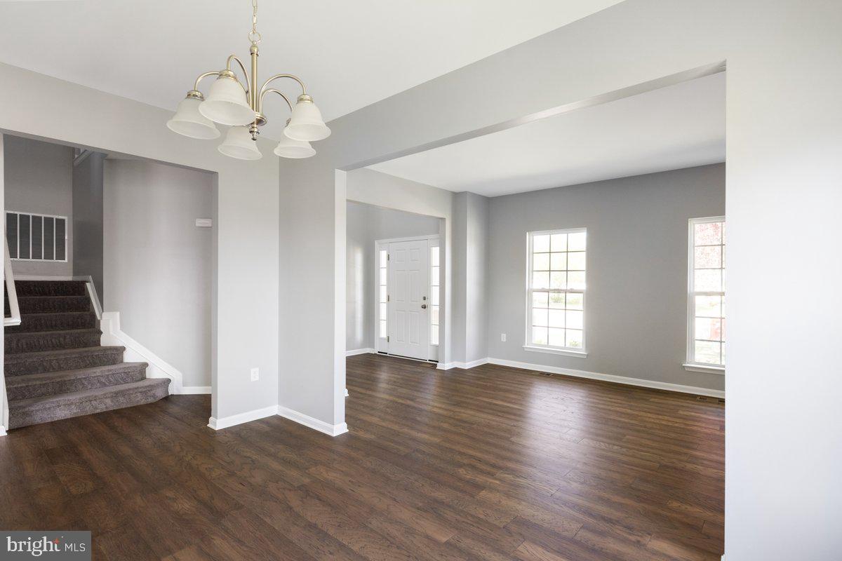 12 Glenbrook Road Ranson, WV 25438 - Photo 2 of 35 a view of an empty room with wooden floor and a window