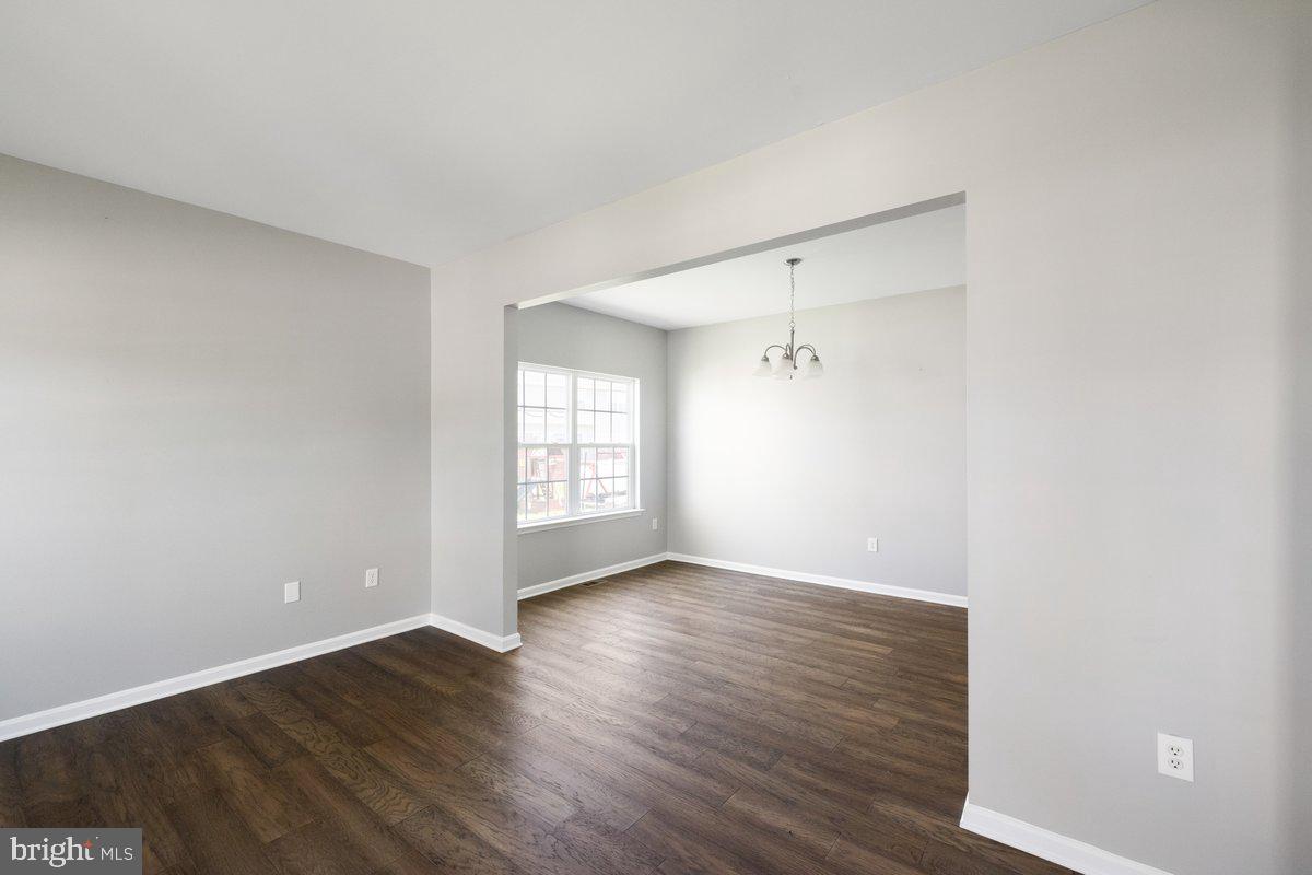 12 Glenbrook Road Ranson, WV 25438 - Photo 4 of 35 a view of an empty room with wooden floor and a window
