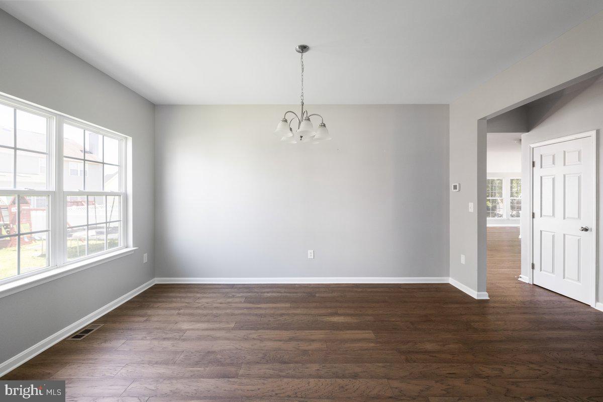 12 Glenbrook Road Ranson, WV 25438 - Photo 5 of 35 wooden floor in an empty room with a window