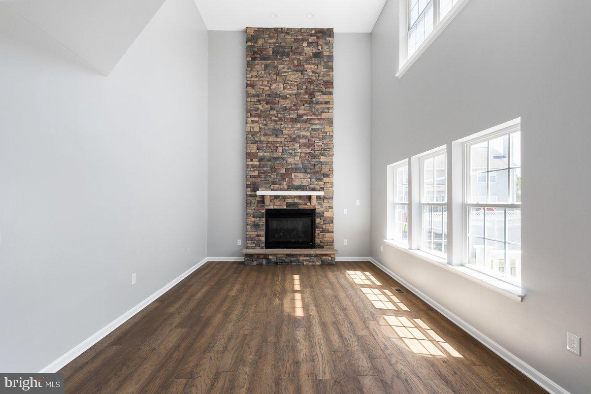 12 Glenbrook Road Ranson, WV 25438 - Photo 6 of 35 an empty room with wooden floor fireplace and windows