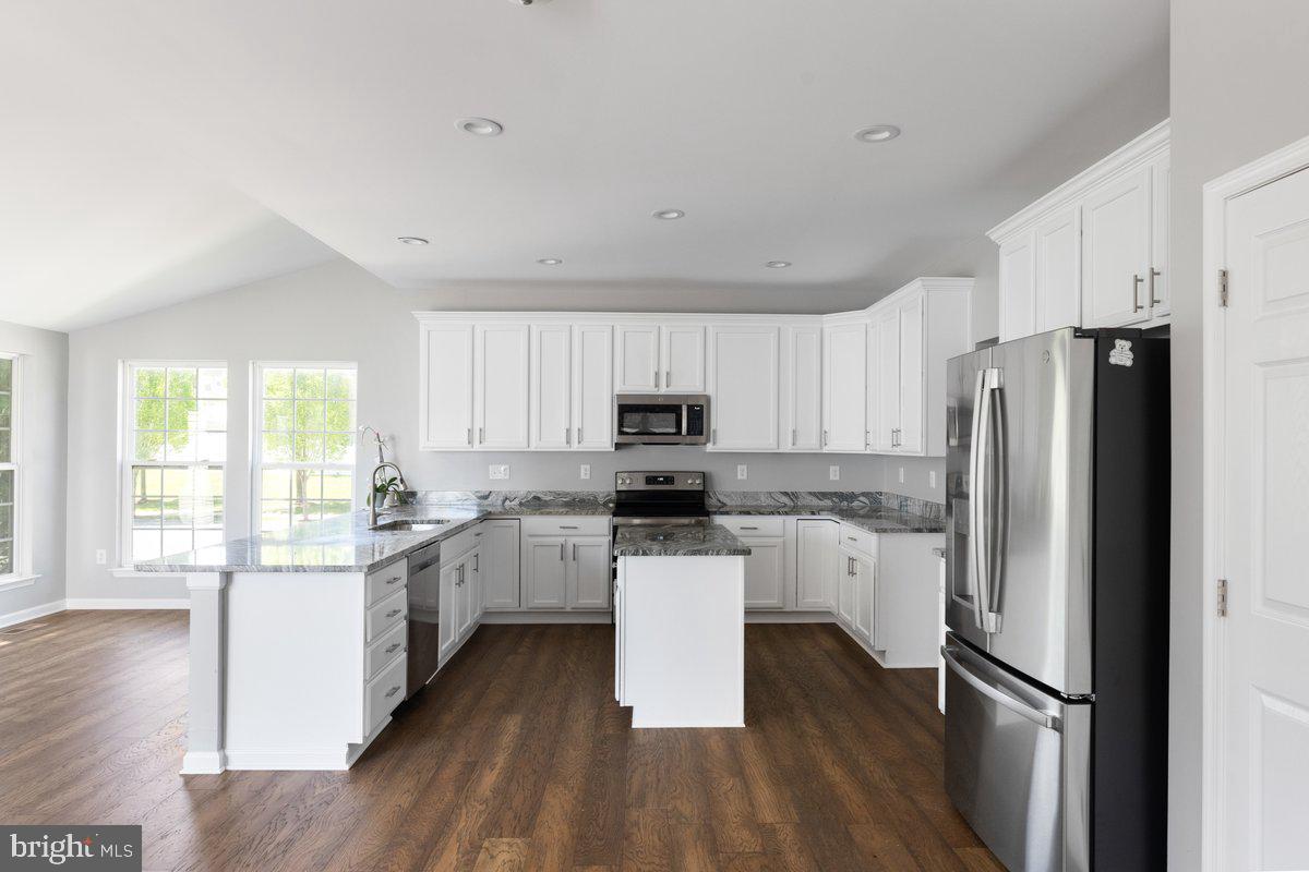 12 Glenbrook Road Ranson, WV 25438 - Photo 9 of 35 a kitchen with stainless steel appliances granite countertop a refrigerator a stove top oven a sink dishwasher and a refrigerator