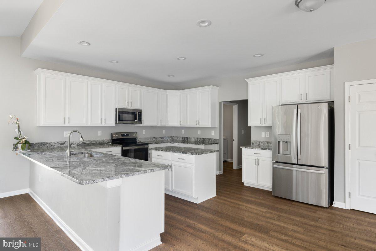 12 Glenbrook Road Ranson, WV 25438 - Photo 10 of 35 a kitchen with a refrigerator sink and cabinets