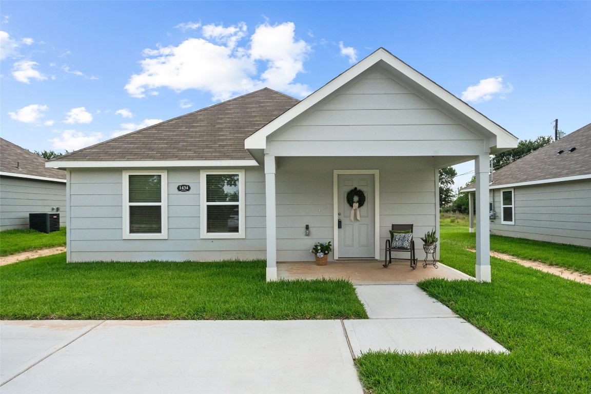 a front view of a house with a yard and porch