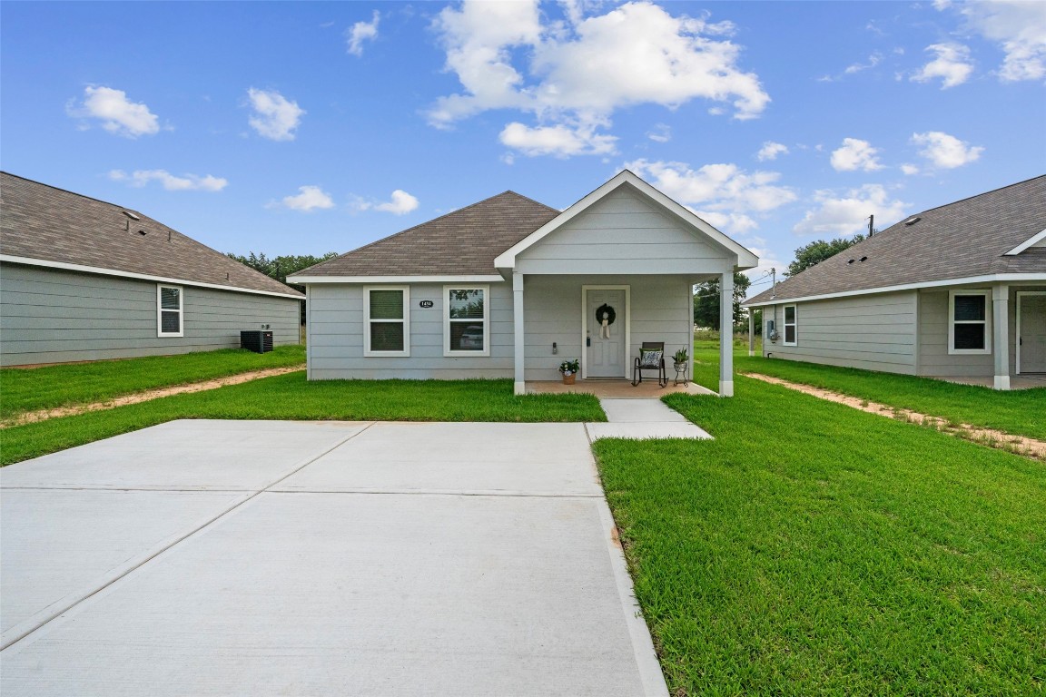 1434 25th Street Hempstead, TX 77445 - Photo 2 of 20 a view of a house with a yard and potted plants