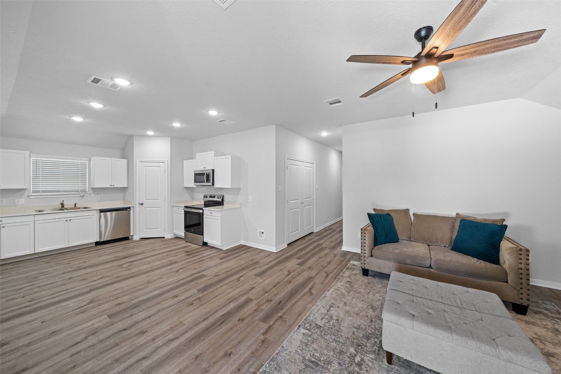 1434 25th Street Hempstead, TX 77445 - Photo 3 of 20 a living room with kitchen island furniture and a kitchen view