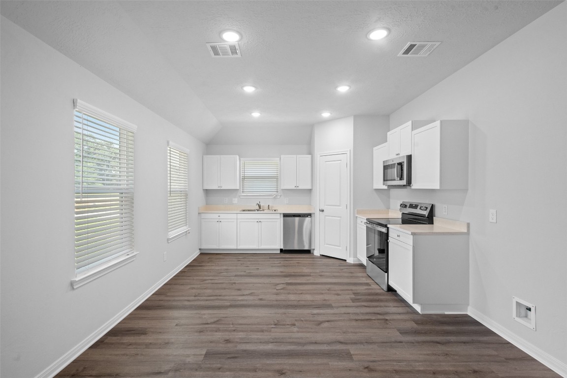1434 25th Street Hempstead, TX 77445 - Photo 7 of 20 a kitchen with a white wooden cabinets and window