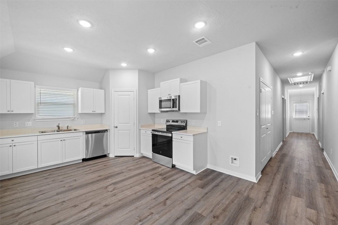 1434 25th Street Hempstead, TX 77445 - Photo 8 of 20 a large kitchen with stainless steel appliances granite countertop a stove and a refrigerator