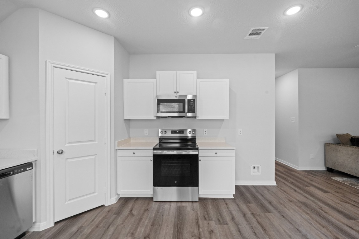 1434 25th Street Hempstead, TX 77445 - Photo 9 of 20 a kitchen with granite countertop a stove and a sink