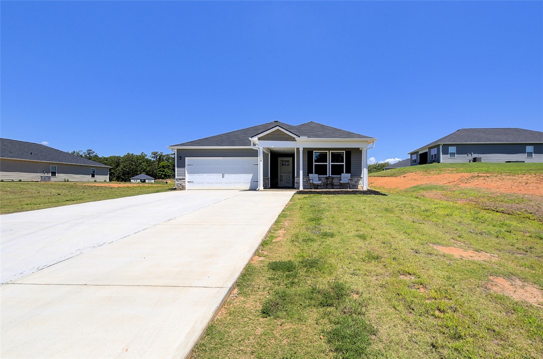 408 Chadwick Lane Walhalla, SC 29691 - Photo 3 of 44 A well-maintained facade with a covered entry and attached garage welcomes residents home.