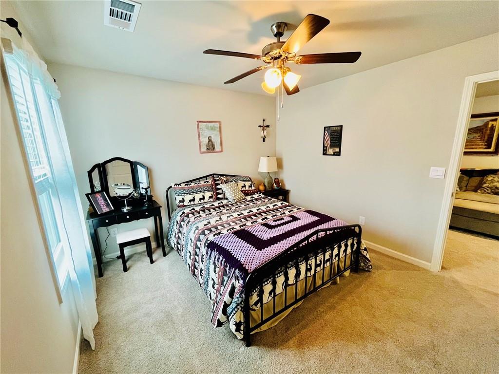 3015 Winding Ridge Waleska, GA 30183 - Photo 31 of 40 a bedroom with a bed and a chandelier