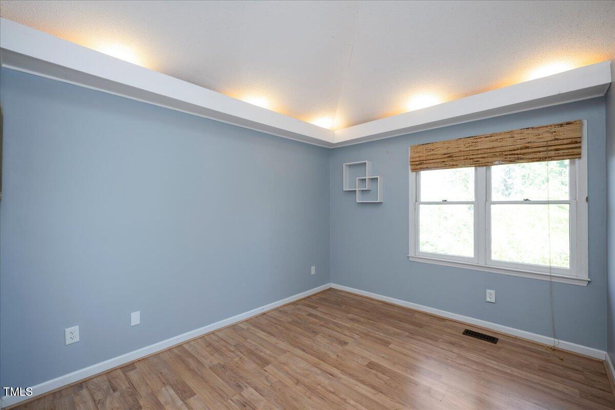 3501 Mill Run Raleigh, NC 27612 - Photo 14 of 24 an empty room with wooden floor and windows