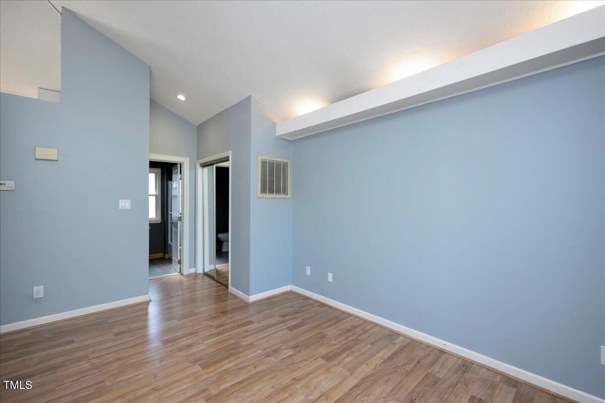 3501 Mill Run Raleigh, NC 27612 - Photo 15 of 24 a view of an empty room with wooden floor