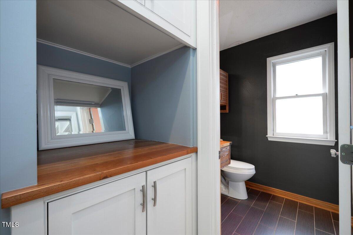 3501 Mill Run Raleigh, NC 27612 - Photo 16 of 24 a room with a wooden floor and a toilet