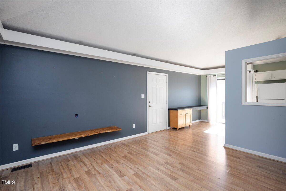 3501 Mill Run Raleigh, NC 27612 - Photo 5 of 24 a view of a room with wooden floor and fence