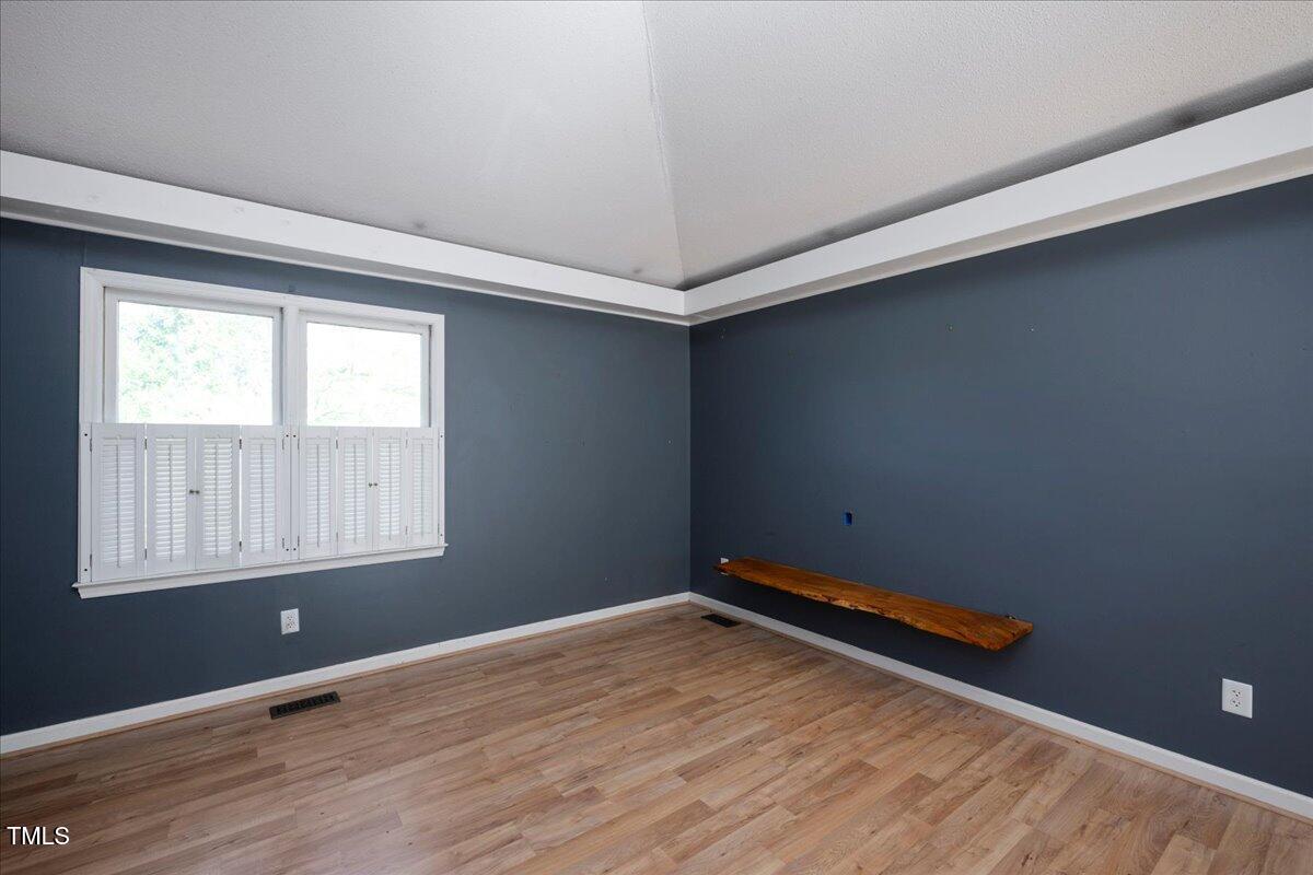 3501 Mill Run Raleigh, NC 27612 - Photo 6 of 24 an empty room with wooden floor and windows