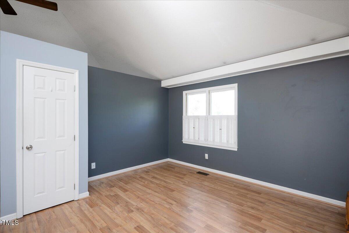 3501 Mill Run Raleigh, NC 27612 - Photo 8 of 24 an empty room with wooden floor and windows