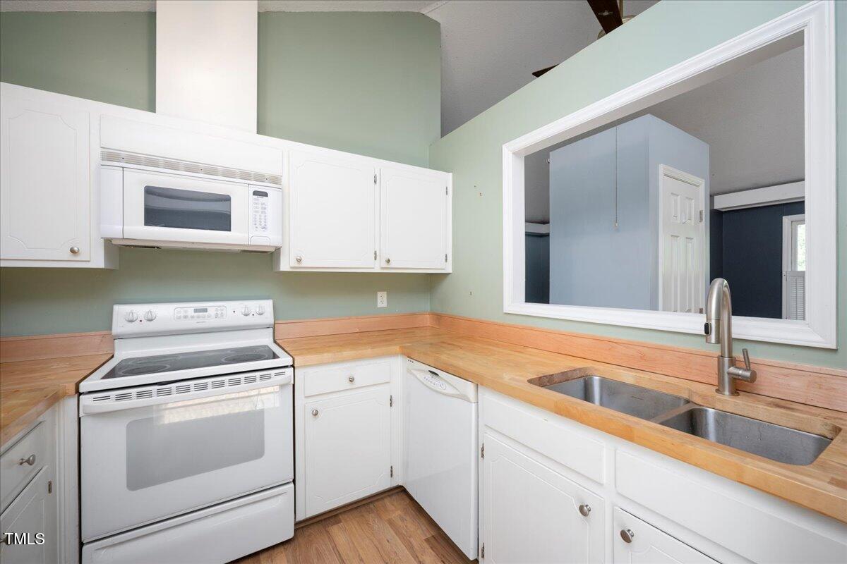 3501 Mill Run Raleigh, NC 27612 - Photo 9 of 24 a kitchen with white cabinets and white appliances