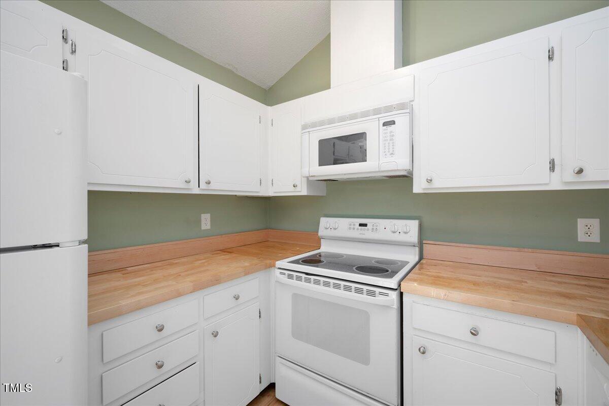 3501 Mill Run Raleigh, NC 27612 - Photo 10 of 24 a kitchen with white cabinets and white appliances
