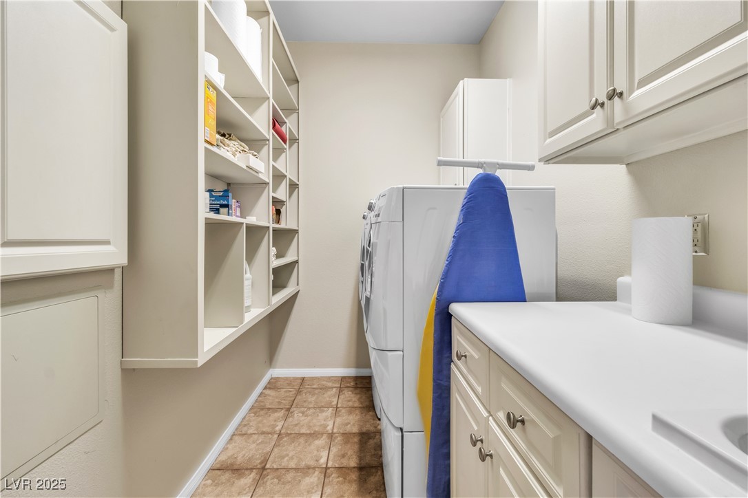 2050 West Warm Springs Road, Unit 1822 Henderson, NV 89014 - Photo 28 of 55 Laundry room featuring light tile patterned floors, baseboards, and cabinet space. Newly installed Maniblock system and whole unit shut off valves.