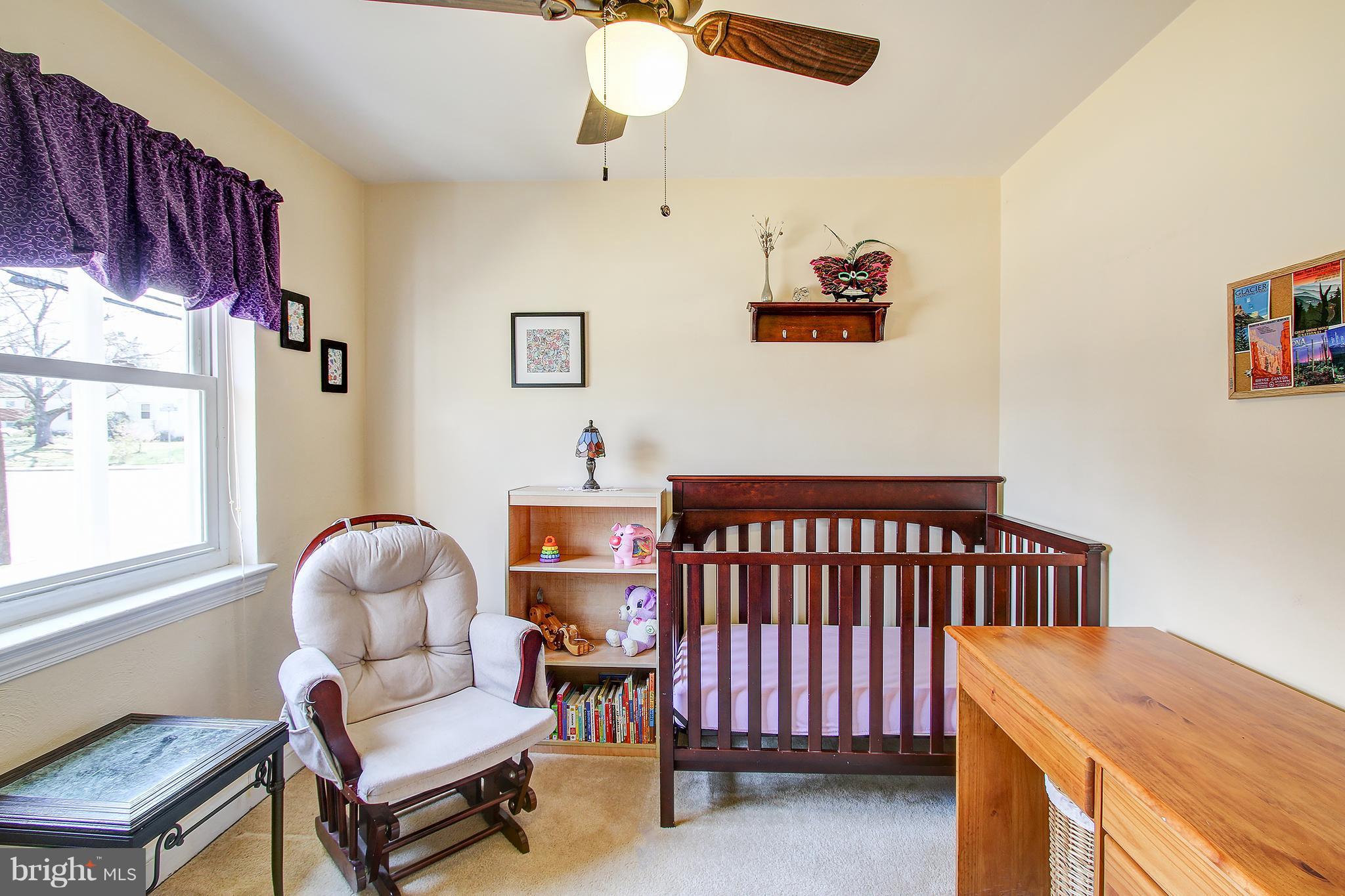 6018 Backlick Road Springfield, VA 22150 - Photo 12 of 26 a bedroom with a bed and a chandelier