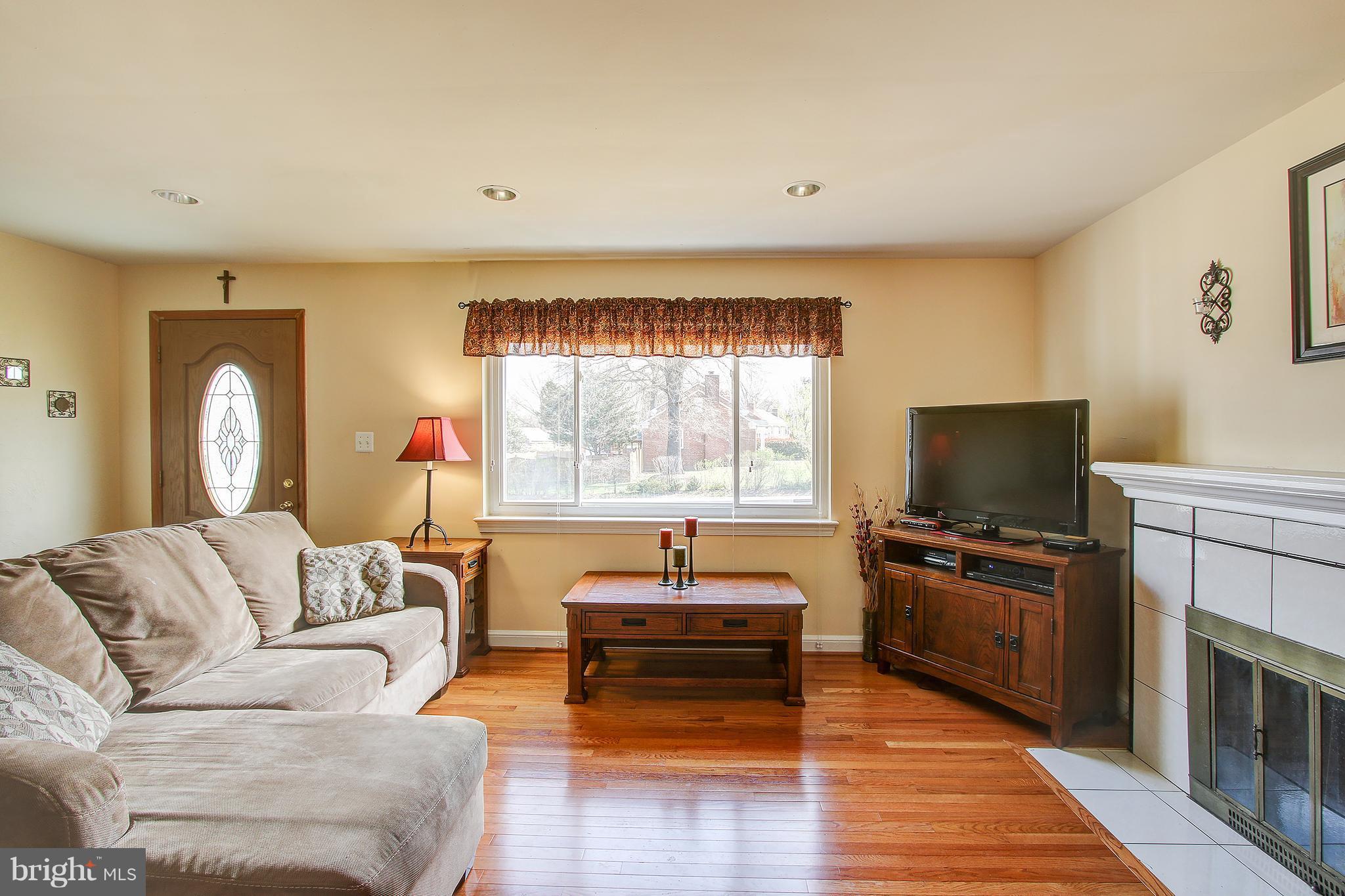 6018 Backlick Road Springfield, VA 22150 - Photo 3 of 26 a living room with furniture and a flat screen tv