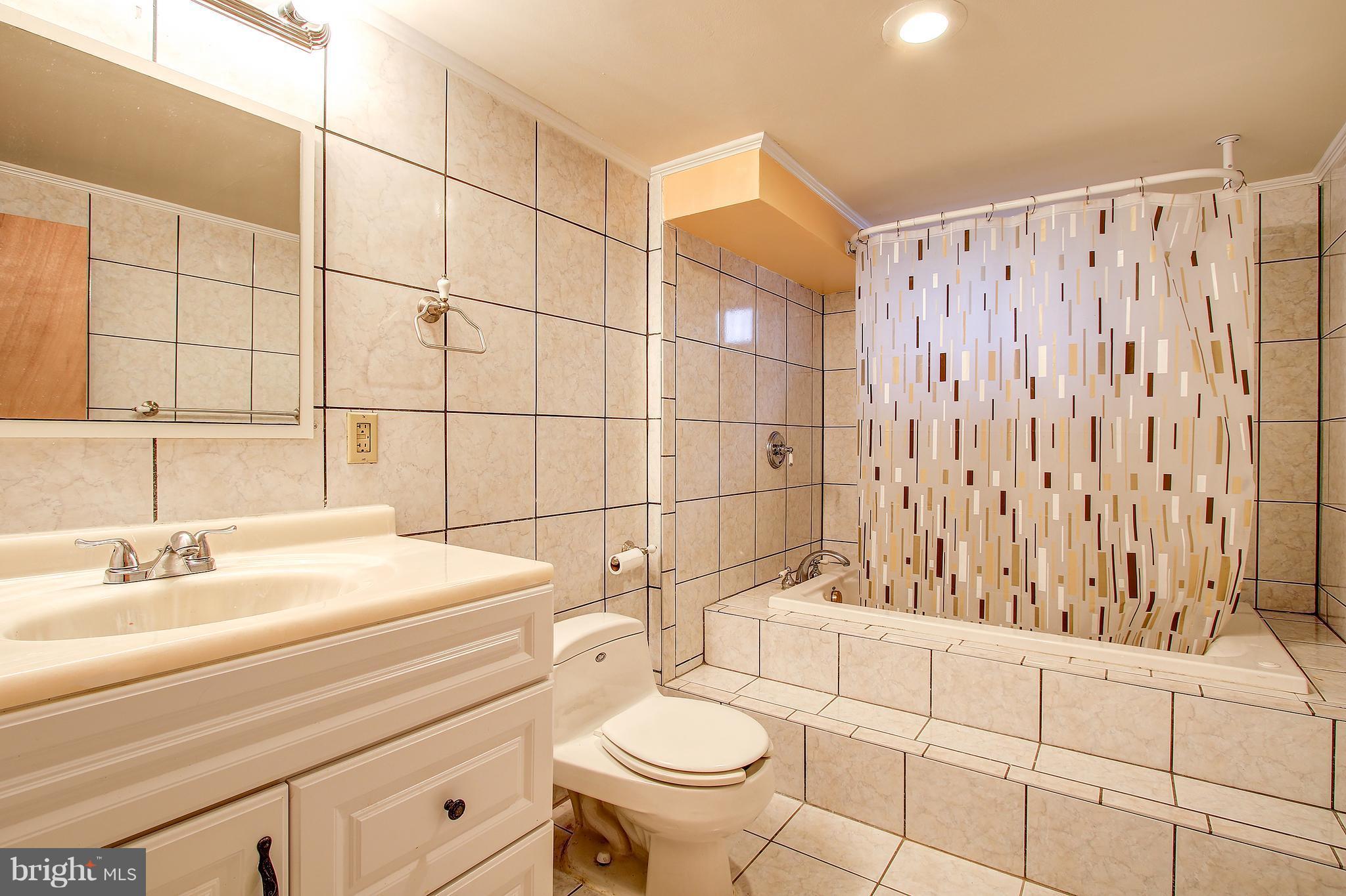 6018 Backlick Road Springfield, VA 22150 - Photo 19 of 26 a bathroom with a sink toilet and shower