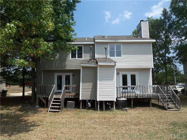 8113 Perry Creek Road, Unit 8115 Raleigh, NC 27616 - Photo 2 of 6 a view of a house with large windows and a large tree