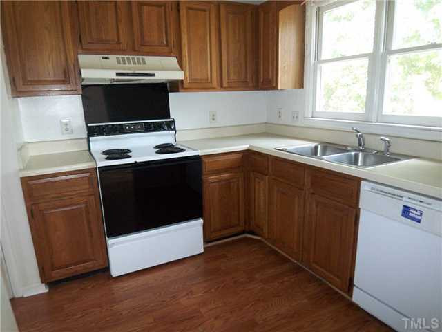 8113 Perry Creek Road, Unit 8115 Raleigh, NC 27616 - Photo 5 of 6 a kitchen with a stove and a sink