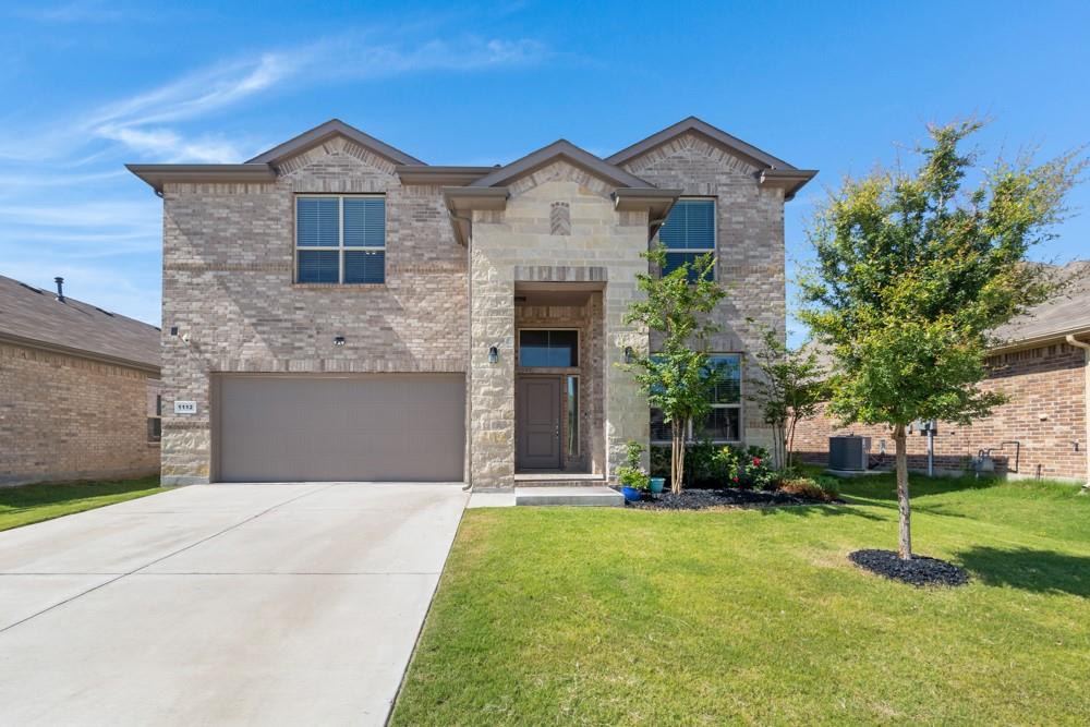 1112 Croxley Way Justin, TX 76247 - Photo 1 of 18 Stone and brick facade featuring a two-car garage, concrete driveway, and established landscaping