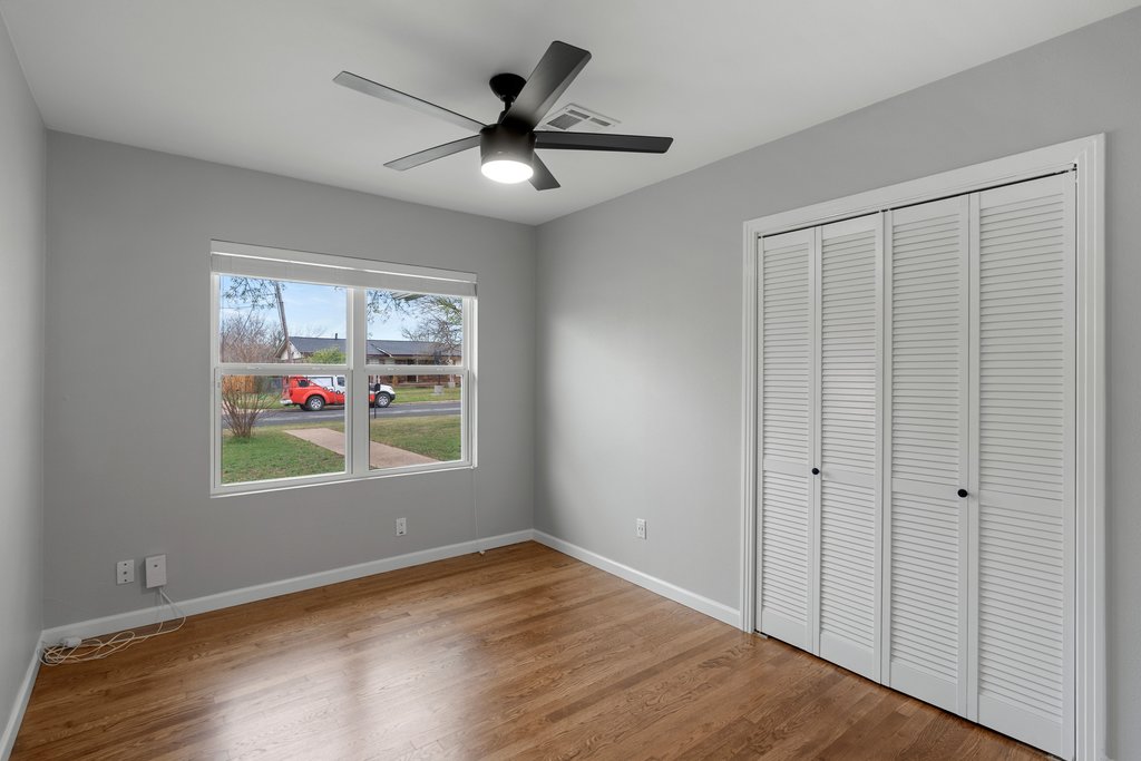 3404 Touchstone Street Austin, TX 78723 - Photo 17 of 33 Unfurnished bedroom featuring wood finished floors, a closet, and a ceiling fan