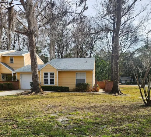 a front view of house with yard and trees around