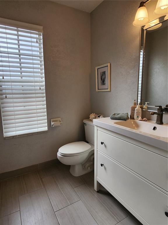 4801 Northwest 2nd Place Gainesville, FL 32607 - Photo 11 of 36 a bathroom with a toilet sink and mirror