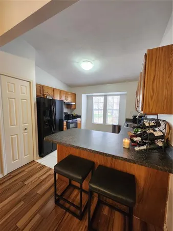 a kitchen with a refrigerator and cabinets