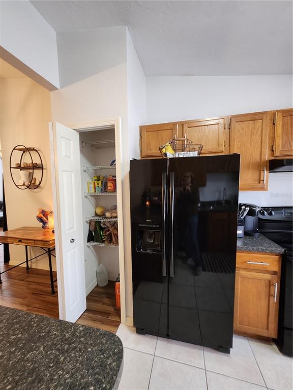 4801 Northwest 2nd Place Gainesville, FL 32607 - Photo 14 of 36 a kitchen with a refrigerator and cabinets