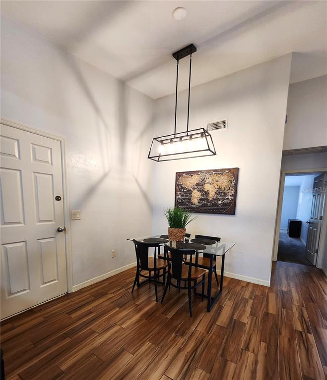4801 Northwest 2nd Place Gainesville, FL 32607 - Photo 15 of 36 a view of a dining room with furniture and wooden floor
