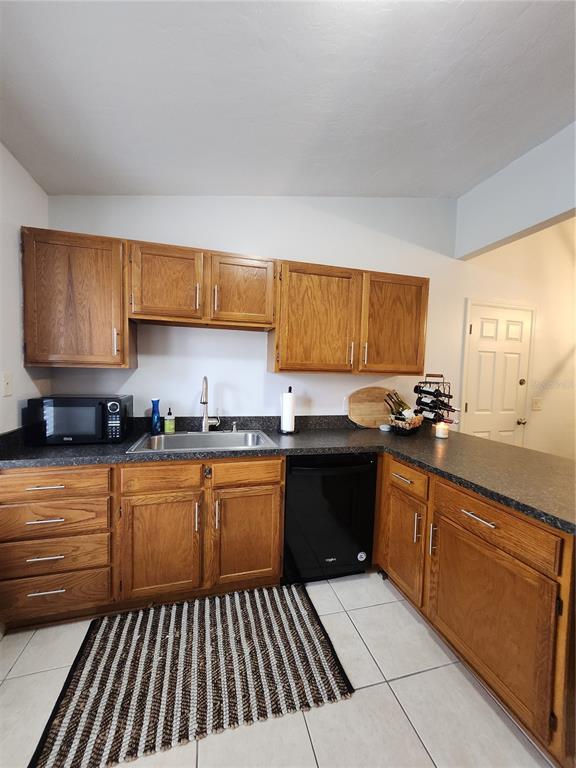 4801 Northwest 2nd Place Gainesville, FL 32607 - Photo 18 of 36 a kitchen with granite countertop a sink stove and cabinets