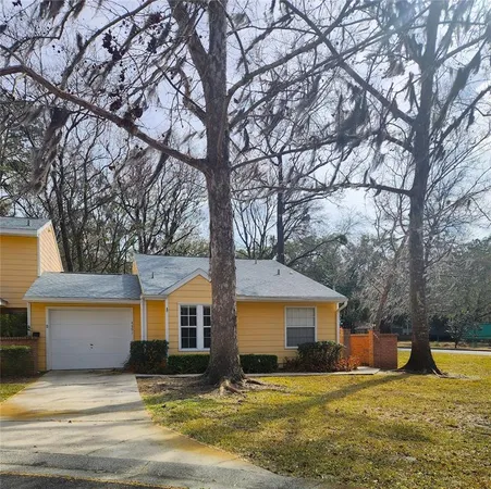 a house that has a tree in front of it