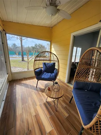 a view of a balcony with wooden floor and iron fence