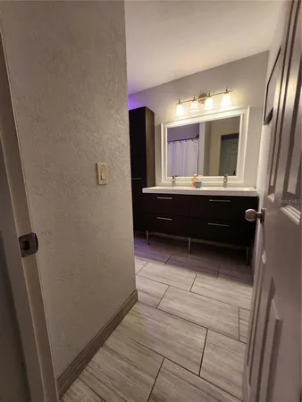 a bathroom with a sink mirror vanity and toilet